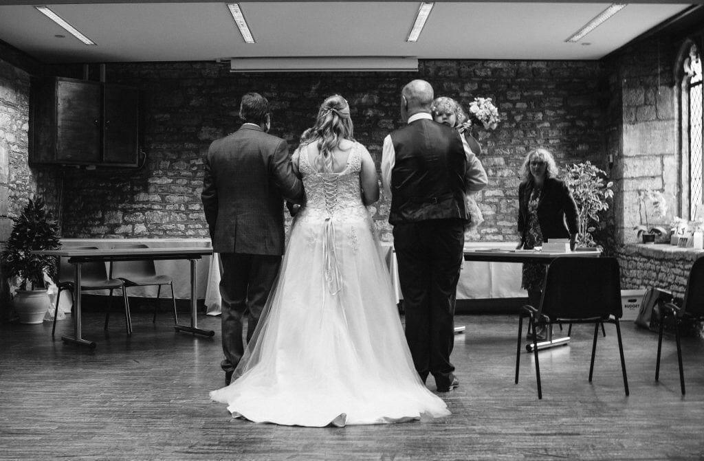 The bride with her father, the groom and their daughter in Abbey Manor, Yeovil.