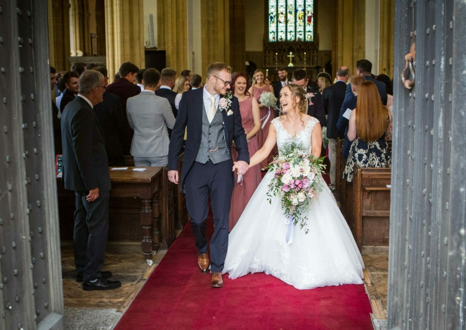 Wedding couple coming out of St Bartholomews Church in Crewkerne, taken by Somerset Wedding Photographer, Victoria Welton