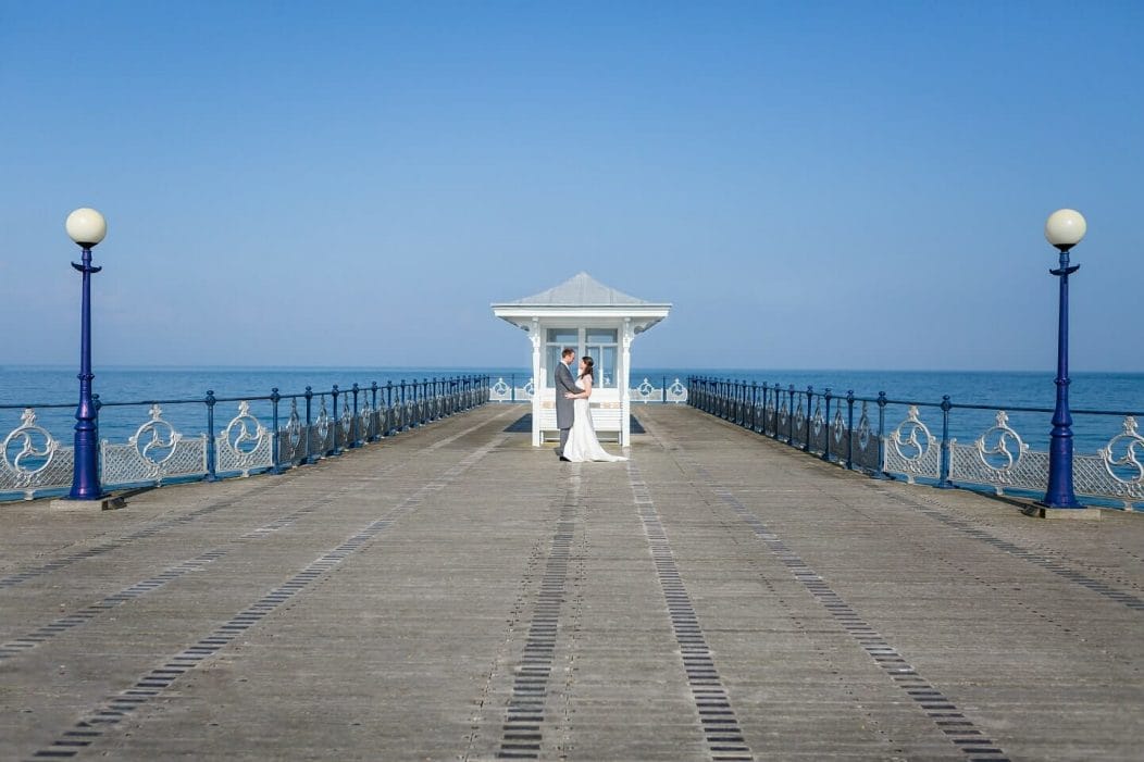 Wedding couple at the end of Swanage Pier, an image taken by Somerset Photographer Victoria Welton